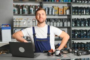 A salesman in an auto parts store. Retail trade of auto parts photo