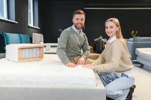 Happy couple choosing furniture in store photo