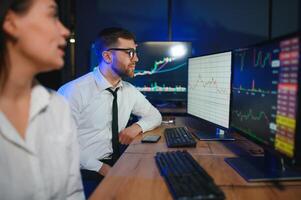 Business team investment working with computer, planning and analyzing graph stock market trading with stock chart data photo