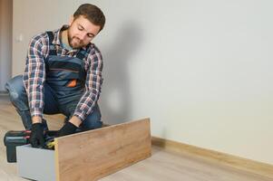 Professional Furniture Assembly Worker Assembles Shelf. Professional Handyman Doing Assembly Job Well photo