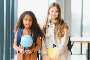 Portrait of happy multiracial elementary schoolgirls. school concept photo