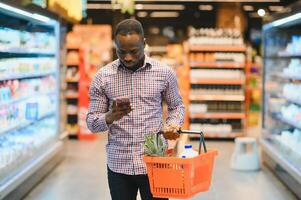 African american Man shopping in a supermarket photo