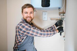 Professional plumber checking a boiler and pipes, boiler service concept photo