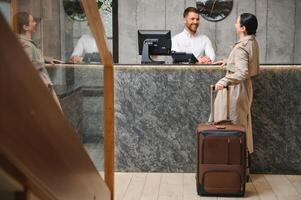 Elegant Business Woman with Travel Trolley Luggage in Hotel Lobby photo