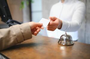 Picture of guests getting key card in hotel photo