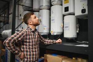 Plumber with boilers, plumbering store photo