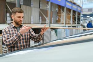 Man choosing flooring in hardware store photo