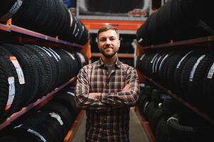 Man chooses winter car tires in the auto shop photo