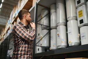 Plumber with boilers, plumbering store photo