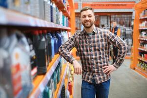 man buys automobile chemicals in the auto parts store photo