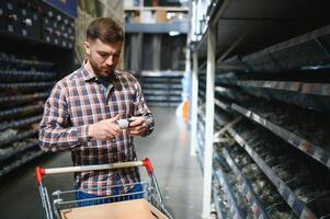 Portrait of happy mature man standing in hardware store photo