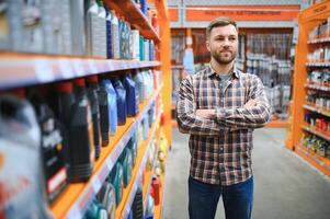 man buys automobile chemicals in the auto parts store photo