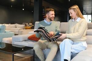 Happy couple choosing furniture in store photo