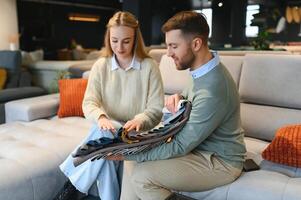 Happy couple choosing furniture in store photo