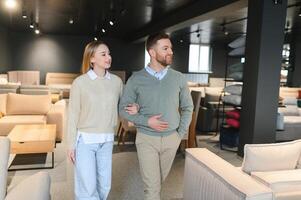 Happy couple choosing furniture in store photo