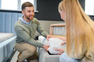 Happy couple choosing furniture in store photo