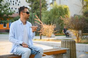 Blinded man waiting for bus at a bus station photo