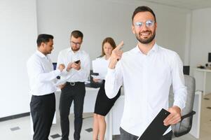 Business people stand on the background of the office corridor photo