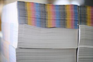 paper pile in a finishing, folder station in an offset printer photo