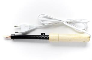 Electric soldering iron with a wooden handle on a white background. A tool for soldering radio components. photo