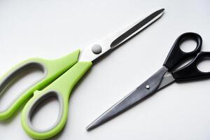 Sewing scissors on a white background. Green scissors. photo