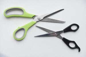 Sewing scissors on a white background. Green scissors. photo