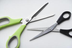 Sewing scissors on a white background. Green scissors. photo