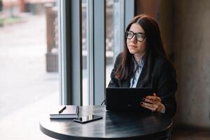 Young businesswoman using tablet computer. woman on a coffee break photo