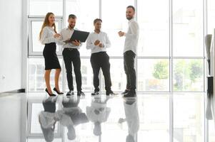 Team at work. Group of young business people in smart casual wear working together in creative office photo