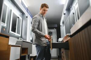 Man choosing a batgh sink with sales person photo