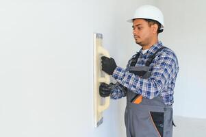 Worker make repairs in new apartment photo