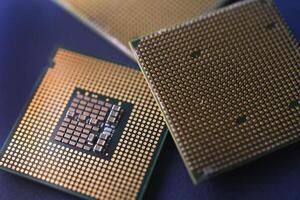 A computer processor on a blue background. Contacts on the processor case. photo