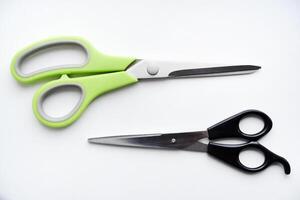 Sewing scissors on a white background. Green scissors. photo