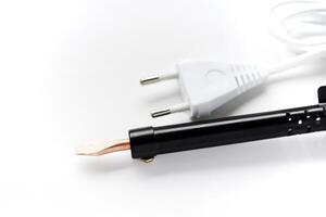 Electric soldering iron with a wooden handle on a white background. A tool for soldering radio components. photo