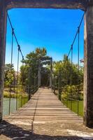 an old suspension bridge in a park, Indonesia, 7 November 2023 photo