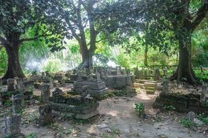 The ancient Islamic burial complex of Sunan Giri is shady with several large trees photo