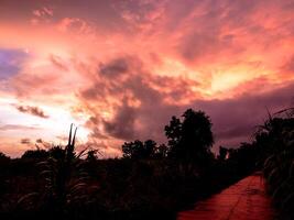 Spectacular sunset over, orange sun rising up over the horizon photo