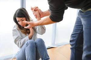 Man beating up his wife illustrating domestic violence photo