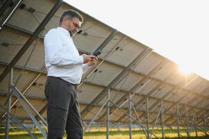 Architect standing by solar panels. photo