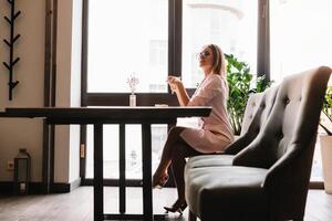 Smiling businesswoman using tablet computer coffee shop photo