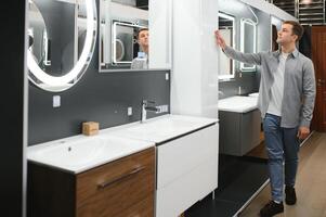 Man choosing a batgh sink with sales person photo