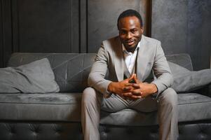 African man in a classic suit on a dark gray background. The concept of classic clothing photo