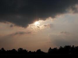 Spectacular sunset over, orange sun rising up over the horizon photo