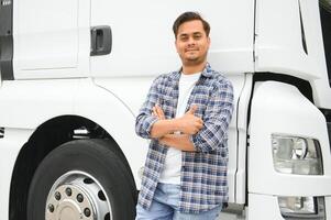 Young indian businessman with his freight forward lorry or truck. photo