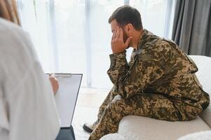Army anger, ptsd and man in therapy with stress from war and a psychologist for support photo
