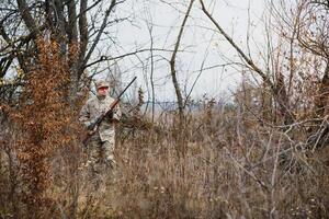 Hunting permit. Man brutal gamekeeper nature background. hunter spend leisure hunting. Hunter hold riffles. Focus and concentration of experienced hunter. Hunting and trapping seasons photo