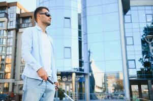 Blind man with a walking stick. photo