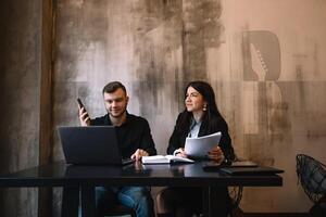 business man and woman working behind laptop. photo