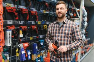 Man shopping for drill in hardware store photo