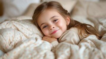 A young girl peacefully rests under a cozy blanket in bed photo